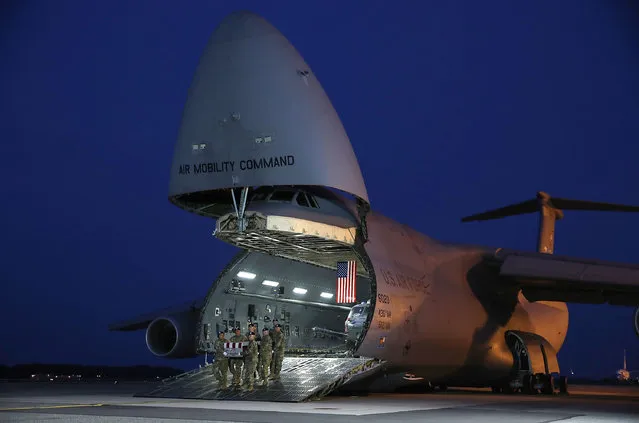 A U.S. Army carry team moves the transfer case containing the remains of U.S. Army Sgt. William M. Bays, during a dignified transfer at Dover Air Force Base, June 12, 2017 in Dover, Delaware. Sgt. Bays who who was from Barstow, CA, died of wounds received during an apparent insider attack by an Afghan soldier in Nangahar Province of Afghanistan on June 10th. (Photo by Mark Wilson/Getty Images)