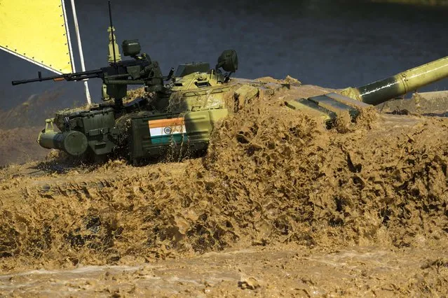 An Indian tank pushes through the water during competition in Alabino, outside Moscow, Russia, Monday, August 3, 2015. (Photo by Pavel Golovkin/AP Photo)