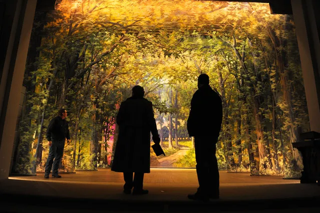 In this photo taken December 22, 2014, from left, Bert Bouma, Mark Viergutz and Kal Poole examine the backdrops at the Consistory Shrine Temple in Helena, Mont. (Photo by Thom Bridge/The Independent Record via AP Photo)