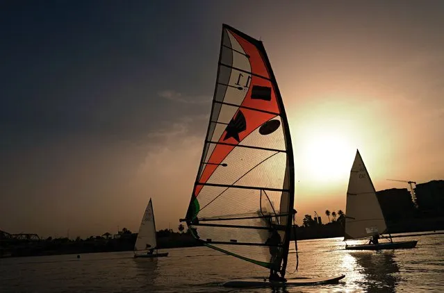 Members of the Iraqi national windsurfing team train in the Tigris River for the Arab. sailing Championships in Baghdad, Iraq, Saturday, May 14, 2022. (Photo by Hadi Mizban/AP Photo)
