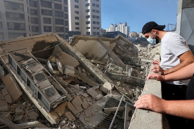 People look at the damage in the aftermath of Israeli strikes in Chiyah, amid the ongoing hostilities between Hezbollah and Israeli forces, Lebanon on October 2, 2024. (Photo by Mohamed Azakir/Reuters)