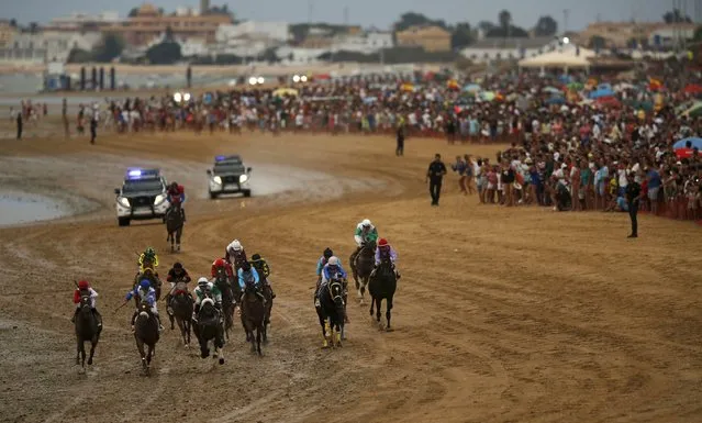 Jockeys ride during a traditional race along the beach of Sanlucar de Barrameda, southern Spain August 12, 2015. (Photo by Marcelo del Pozo/Reuters)