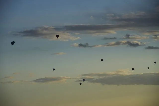 Balloons fly during sunset over Yakhroma, about 75 kilometers (47 miles) north from Moscow, Russia, Thursday, June 16, 2022. (Photo by Alexander Zemlianichenko/AP Photo)