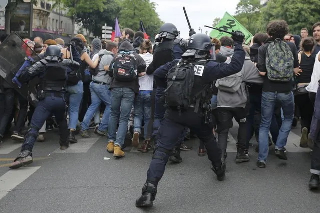 French police push back protestors who attend a demonstration against plans to reform French labour laws in Paris, France, June 28, 2016. (Photo by Stephane Mahe/Reuters)