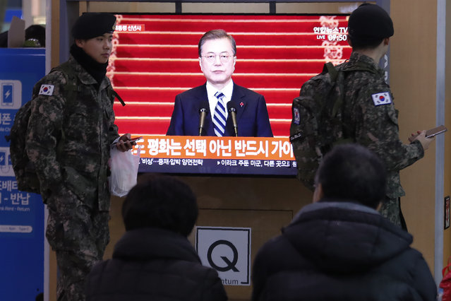 South Korean army soldiers pass by a TV screen showing the live broadcast of South Korean President Moon Jae-in's New Year's speech at the Seoul Railway Station in Seoul, South Korea, Tuesday, January 7, 2020. Moon said he hopes to see North Korean leader Kim Jong Un fulfill a promise to visit the South this year as he called for the rival Koreas to end a prolonged freeze in bilateral relations. (Photo by Ahn Young-joon/AP Photo)