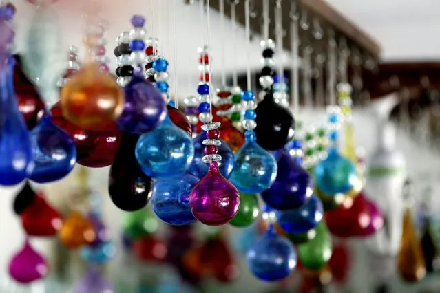 Balls of colored glass are seen in the Khalifeh handicraft workshop, Sarafand village, southern Lebanon, 30 June 2016. The Khalifeh family still use the Phoenician oven to mold glass in the glassblowing workshop in the southern coastal village of Sarafand, they were given a new lease of life thanks to an initiative for recycling waste glass normally destined for landfills. Their factory recycle stained glass or transparent glass bottles of all kinds which are collected from restaurants or from broken glass. The plant produces pitchers, cups, vases, tables, candles and colored glass bottles, as well as granular beads and balls of forms, colors and sizes, made professionally neat, displayed in a shop at Sarafand, waiting for tourists or Lebanese visitors to buy. (Photo by Nabil Mounzer/EPA)