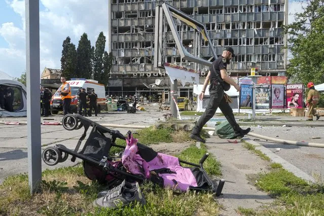 A baby stroller lies by a road after a deadly Russian missile attack in Vinnytsia, Ukraine, Thursday, July 14, 2022. (Photo by Efrem Lukatsky/AP Photo)