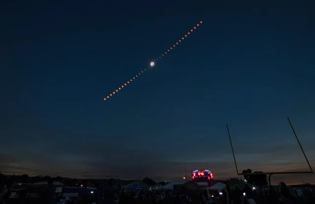 A handout photo made available by NASA shows a composite image showing the progression of a total solar eclipse over Madras, Oregon, USA, 21 August 2017. A total solar eclipse swept across a narrow portion of the contiguous United States from Lincoln Beach, Oregon to Charleston, South Carolina. A partial solar eclipse was visible across the entire North American continent along with parts of South America, Africa, and Europe. (Photo by Aubrey Gemignani/EPA/NASA)