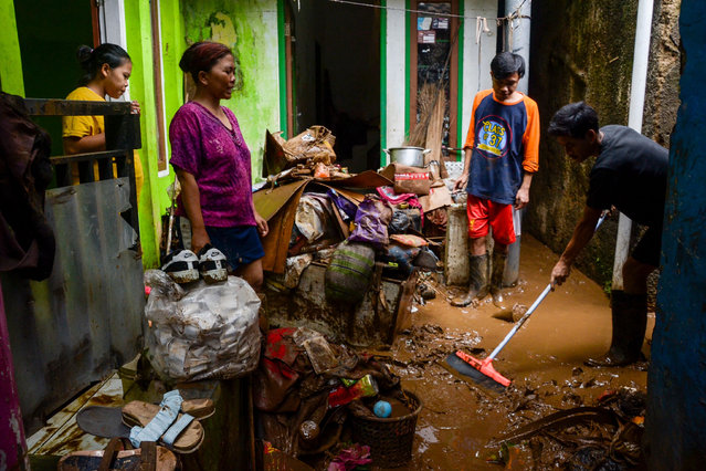 Residents clean up a puddle of mud in front of their house in Banjaran Wetan Village, Bandung Regency, West Java on November 6, 2024. Heavy rains on Tuesday hit this village causing flash floods. (Photo by Dimas Rachmatsyah/ZUMA Press Wire/Rex Features/Shutterstock)