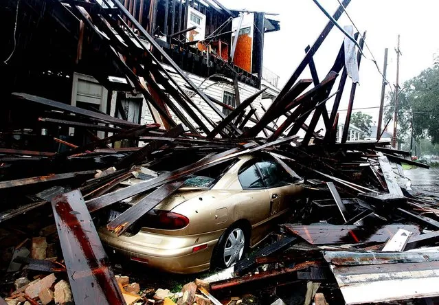 A house at the corner of N. Miro and Columbus Streets in New Orleans collapsed during the height of Hurricane Isaac, destroying three vehicles that where parked alongside it. (Photo by David Grunfeld/The Times-Picayune)