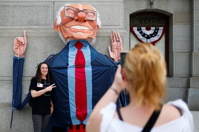 A supporter of U.S. Senator Bernie Sanders poses with his effigy at City Hall ahead of the 2016 Democratic National Convention in Philadelphia, Pennsylvania, July 24, 2016. (Photo by Adrees Latif/Reuters)
