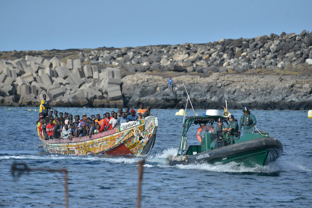 Migrants arrive at La Restinga Port in El Hierro, Canary Islands, Spain, 23 October 2023. A total of five dugout canoes with 570 migrants on board have arrived to the Canary Islands throughout the day. (Photo by Gelmert Finol/EPA/EFE)