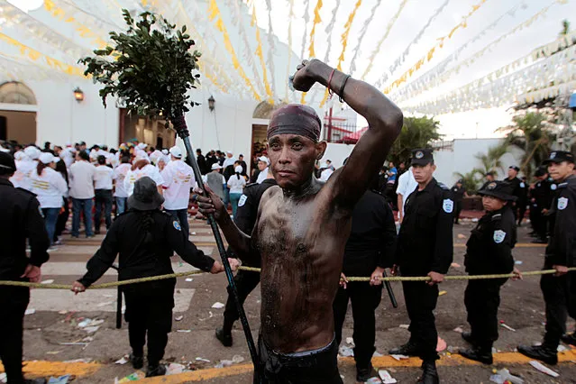 A man covered in motor oil takes part in the festivities honouring the capital's patron saint Santo Domingo de Guzman in Managua, Nicaragua August 1, 2016. (Photo by Oswaldo Rivas/Reuters)