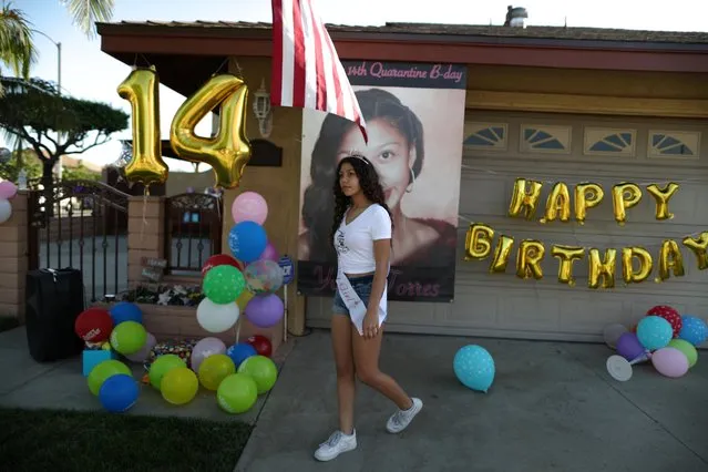 Yvette Torres, 14, celebrates her birthday with a drive-by party outside her home as the global outbreak of coronavirus (COVID-19) continues, in Pico Rivera, near Los Angeles, California, U.S., April 27, 2020. (Photo by Lucy Nicholson/Reuters)