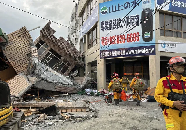 This photo provided by Hualien County fire department show firefighters in the search for trapped victims in a collapsed residential building following earthquake in Yuli township in Hualien County, eastern Taiwan, Sunday, September 18, 2022. (Photo by Hualien County Fire Department via AP Photo)