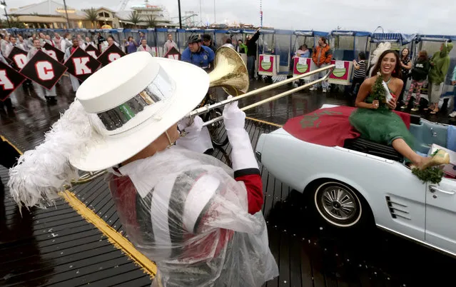 A member of the Jackson Memorial High School band, left, of Jackson, N.J., serenades Miss Vermont Lucy Edwards during the Miss America Shoe Parade at the Atlantic City boardwalk, Saturday, September 13, 2014, in Atlantic City, N.J. (Photo by Julio Cortez/AP Photo)