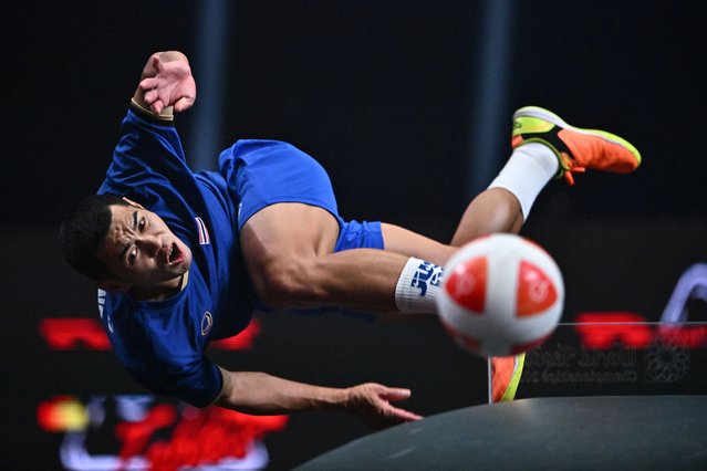 Thailand’s Phakpong Dejaroen returns the ball against Brazil’s Vania Moraes De Cruz and Leonardo Lindoso De Almeida during the mixed doubles final match of the World Teqball Championships at the Bangkok Arena in Bangkok on December 3, 2023. (Photo by Lillian Suwanrumpha/AFP Photo)
