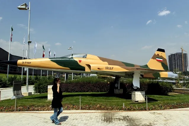 A woman walks past an American-made aircraft F5 (Tiger) at Holy Defence Museum in Tehran September 23, 2015. (Photo by Raheb Homavandi/Reuters/TIMA)