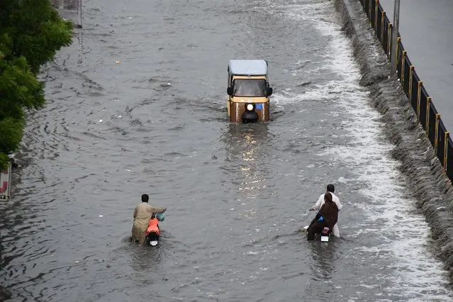 A view of a flooded road after heavy monsoon rains in Karachi, Pakistan on July 26, 2020. (Photo by Sabir Mazhar/Anadolu Agency via Getty Images)