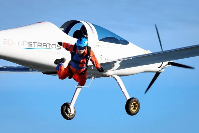 Initiator of sun-powered stratospheric SolarStratos plane project Raphael Domjan jumps during a successful world record attempt by jumping with a parachute from a solar-powered plane on August 25, 2020 in Payerne, western Switzerland. The SolarStratos, a sleek, white, two-seater aircraft with long wings, covered with 22 square metres (237 square feet) of solar panels is set to become the first manned solar plane to make a stratospheric flight, according to Raphael Domjan, who is behind the project. (Photo by Laurent Gillieron/Pool via Reuters)