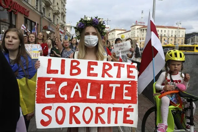 Women with old Belarusian national flags and a poster, echoing the national motto of France, during an opposition rally to protest the official presidential election results in Minsk, Belarus, Saturday, September 5, 2020. (Photo by AP Photo/Stringer)