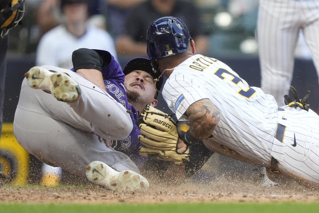 Milwaukee Brewers' Joey Ortiz (3) scores on a wild pitch past a tag by Colorado Rockies' Victor Vodnik, left, during the 10th inning of a baseball game Sunday, June 29, 2025, in Milwaukee. (Photo by Aaron Gash/AP Photo)