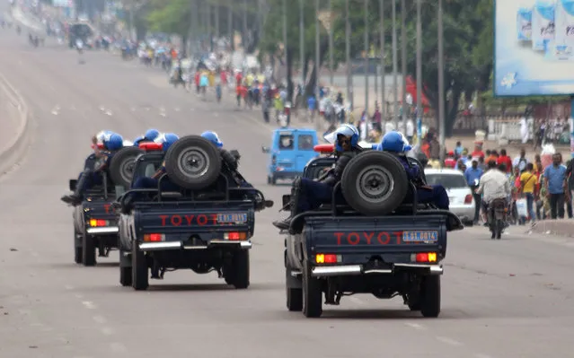 Congo riot police patrol streets on trucks, after violence erupted due to the delay of the presidential elections in Kinshasa, Democratic Republic of Congo, Tuesday, September 20, 2016. More than 44 people have been killed in Congo in two days of street clashes between security forces and protesters, a senior Human Rights Watch researcher said Tuesday, and several opposition party buildings were burned. (Photo by John Bompengo/AP Photo)