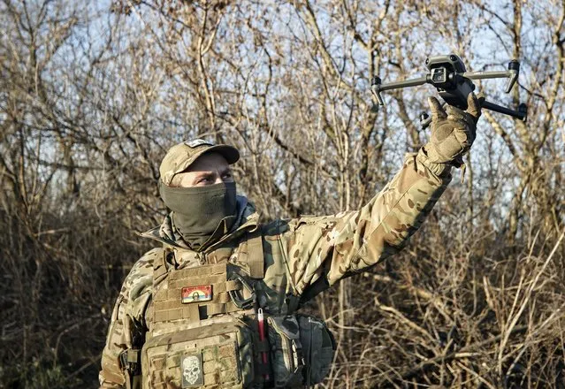 A Ukrainian serviceman flies a drone during an operation against Russian positions at an undisclosed location in the Donetsk region, Ukraine, Sunday, December 4, 2022. (Photo by Roman Chop/AP Photo)
