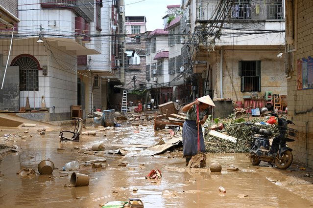 A resident cleans up a street after heavy rainfall led to flooding, in Huaiji county of Zhaoqing, Guangdong province, China on June 19, 2025. (Photo by cnsphoto via Reuters)