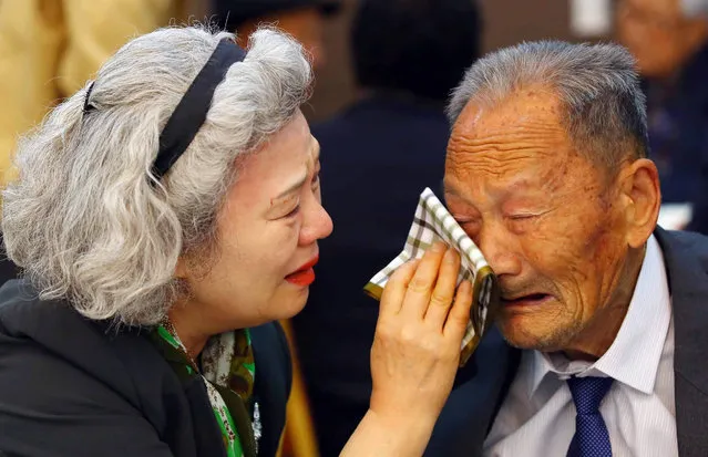 South Korean Lee Jung-sook (L), 68, wipes the tears from her North Korean father Lee Heung-jong, 88, as they bid each other a sad farewell at a resort on Mount Kumgang, North Korea, 22 October 2015. About 390 South Koreans arrived at the resort two days ago for the first face-to-face reunion of families separated by the 1950-53 Korean War in nearly 20 months. A second group of some 260 South Koreans will do the same for three days starting on 24 October. (Photo by Yonhap/EPA)