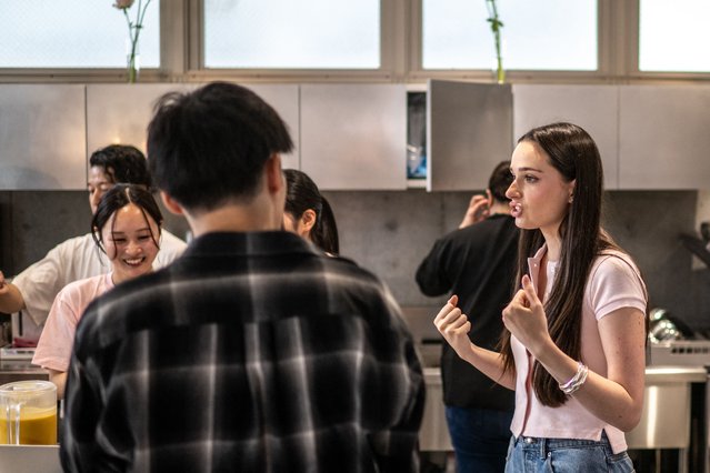 This picture taken on May 31, 2025 shows Andie Ella, the founder of Milia Matcha talking to employees before the shop opening in Tokyo. The word matcha means “ground tea” in Japanese, and comes in the form of a vivid green powder that is whisked with hot water and can be added to milk to make a matcha latte. (Photo by Philip Fong/AFP Photo)