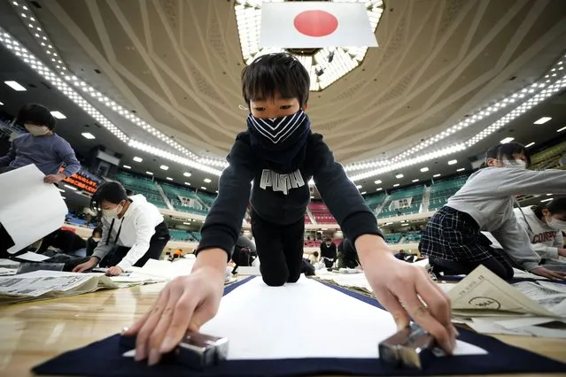 A contestant prepares his paper during the annual New Year's calligraphy contest at the Budokan martial arts hall Thursday, January 5, 2023, in Tokyo. (Photo by Eugene Hoshiko/AP Photo)