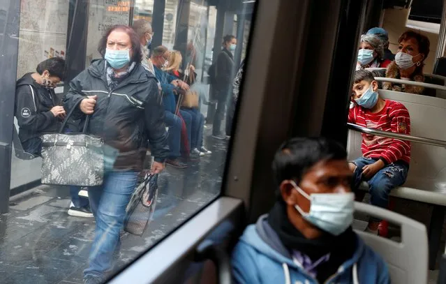 Passengers wearing protective face masks travel on a bus, as Italy adopts new restrictions aimed at curbing a surge in the coronavirus disease (COVID-19) infections, in Rome, Italy on October 15, 2020. (Photo by Yara Nardi/Reuters)