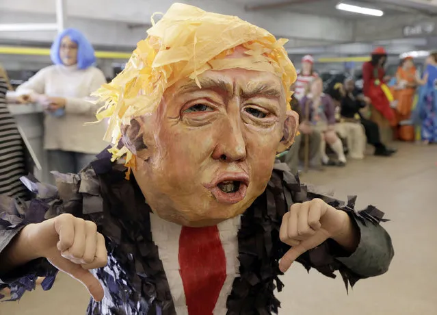 Alia Yusuf wears a "Donald Trump" mask before the taping of a Halloween themed television show at Warner Bros. Studio in Burbank, Calif., on Thursday, October 29, 2015. (Photo by Nick Ut/AP Photo)