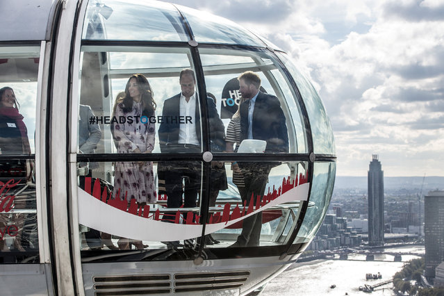 Britain's Princes' William and Harry, and Kate The Duchess of Cambridge take a ride in a pod of the London Eye with members of the mental health charity “Heads together” on world mental health day in London, Britain October 10, 2016. (Photo by Richard Pohle/Reuters)
