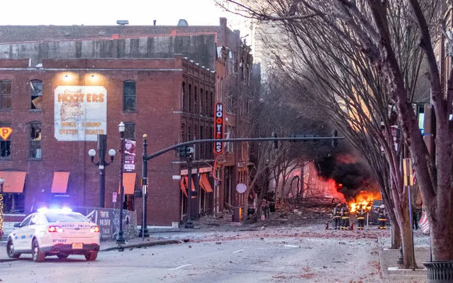 In this photo from the Twitter page of the Nashville Fire Department, damage is seen on a street after an explosion in Nashville, Tennessee on December 25, 2020. An explosion that rocked downtown Nashville causing extensive damage on Christmas morning was linked to a vehicle and appeared to be an “intentional act”, police said. (Photo by Handout/Nashville Fire Department via Reuters)