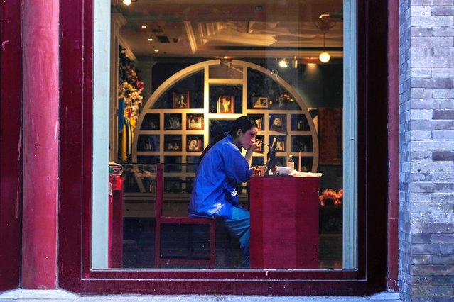 A women gets makeup to take souvenir photograph at Qianmen Street in Beijing, Sunday, July 20, 2025. (Photo by Mahesh Kumar A./AP Photo)