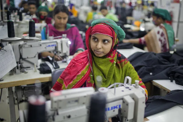 In this April 19, 2018 photo, Bangladeshi garment worker Khadiza Begum, 23, who worked at the Rana Plaza garment factory that collapsed five years ago, works at a garment factory in Dhamrai, near Dhaka, Bangladesh. (Photo by A.M. Ahad/AP Photo)
