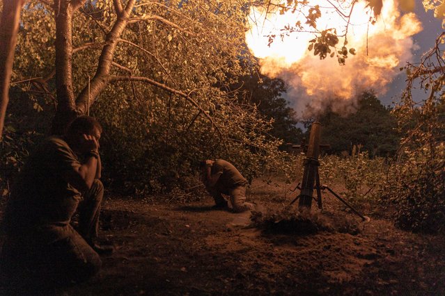 Ukrainian soldiers of a mortar unit cover their ears during the mortar fire in the direction of Toretsk, on August 17, 2024 in Donetsk Oblast, Ukraine. (Photo by Diego Herrera Carcedo/Anadolu via Getty Images)