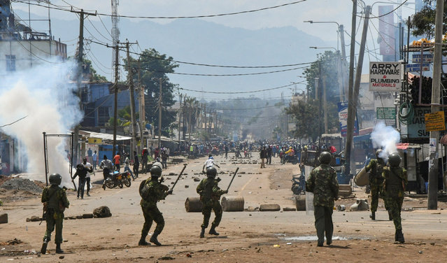 Riot police officers lob teargas canisters to disperse supporters of Kenya's opposition leader Raila Odinga of the Azimio La Umoja (Declaration of Unity) One Kenya Alliance, during protests over cost of living and Kenyan President William Ruto's government, in Kisumu, Kenya on May 2, 2023. (Photo by James Keyi/Reuters)