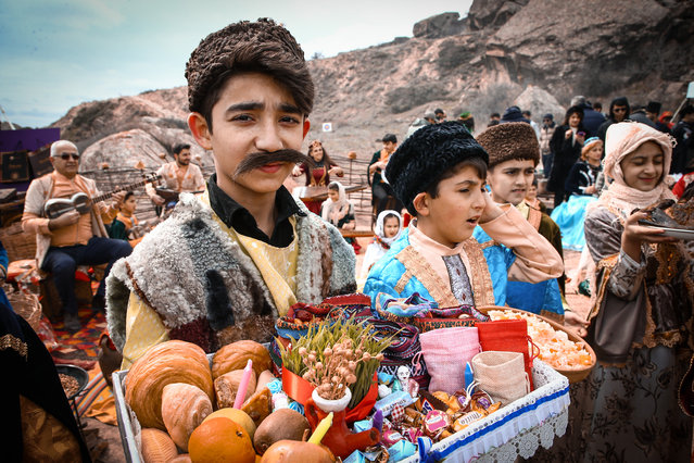 People celebrate Nowruz, considered as the harbinger of spring, awakening of nature and brotherhood, with traditional costumes and at Gobustan National Park in Baku, Azerbaijan on March 21, 2022. People from different regions of Azerbaijan attended celebration with colorful dresses and various music groups performed. (Photo by Resul Rehimov/Anadolu Agency via Getty Images)