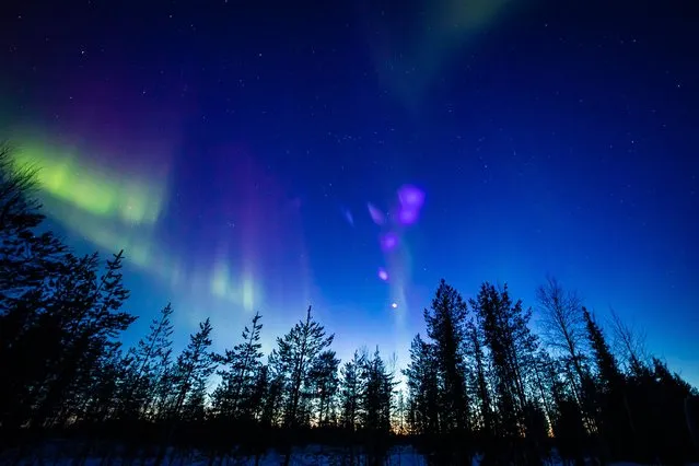 Picture made available by “All About Lapland” on March 24, 2023 and taken on on late March 23, 2023 shows colourful northern lights (Aurora borealis) appearing around the Arctic Circle near Rovaniemi, Finland. (Photo by Alexander Kuznetsov/All About Lapland/AFP Photo)