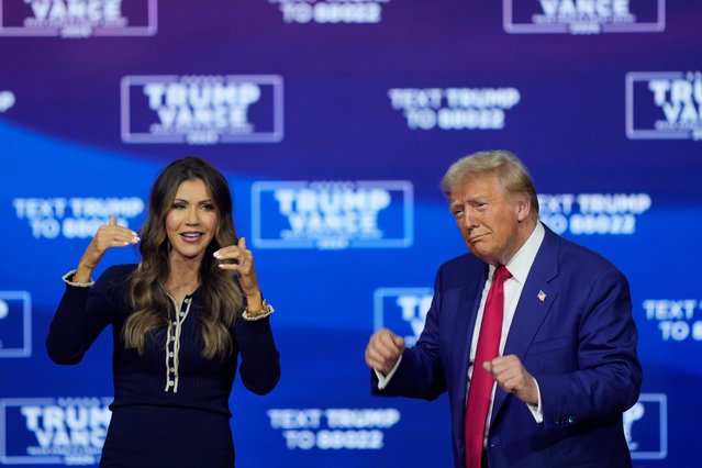 Republican presidential nominee former President Donald Trump and South Dakota Gov. Kristi Noem dance to the song “Y.M.C.A.” at a campaign town hall at the Greater Philadelphia Expo Center & Fairgrounds, Monday, October 14, 2024, in Oaks, Pa. (Phoot by Matt Rourke/AP Photo)