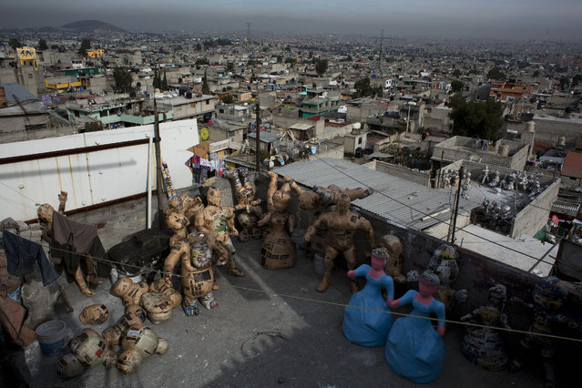 In this January 23, 2015 photo, piñatas in various stages of preparation dry on the rooftop terrace of craftsman Melesio Vicente Flores and his family, in the Iztapalapa neighborhood of Mexico City. After drying in the sun, the piñatas are brought inside to be painted. It takes about two days to complete a piñata during the dry season, twice as long during the rains. (Photo by Rebecca Blackwell/AP Photo)