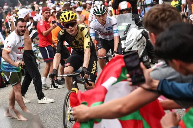 Jumbo-Visma's Danish rider Jonas Vingegaard (L) and UAE Team Emirates' Slovenian rider Tadej Pogacar (R) cycle in a lead breakaway in the final ascent of the Col de Cauterets-Cambasque during the 6th stage of the 110th edition of the Tour de France cycling race, 145 km between Tarbes and Cauterets-Cambasque, in the Pyrenees mountains in southwestern France, on July 6, 2023. (Photo by Anne-Christine Poujoulat/AFP Photo)