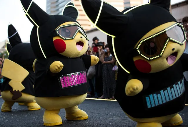 Performers dressed as Pikachu, a character from Pokemon series game titles, march during the Pikachu Outbreak event hosted by The Pokemon Co. on August 10, 2018 in Yokohama, Kanagawa, Japan. (Photo by Tomohiro Ohsumi/Getty Images)