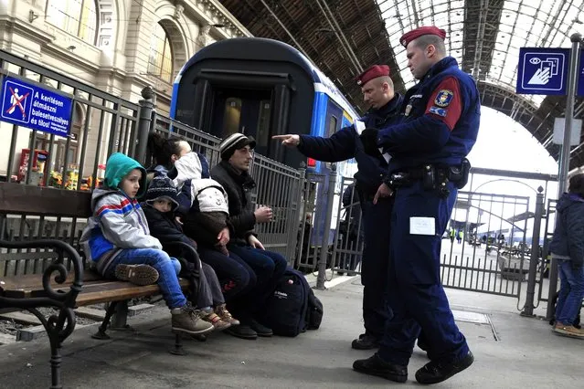 Hungarian policemen check the documents of Kosovars in Keleti (Eastern) railway station in Budapest, February 10, 2015. The European Union is experiencing a steep rise in the number of Kosovo citizens smuggling themselves into the affluent bloc, with 10,000 filing for asylum in Hungary in just one month this year compared to 6,000 for the whole of 2013. (Photo by Bernadett Szabo/Reuters)