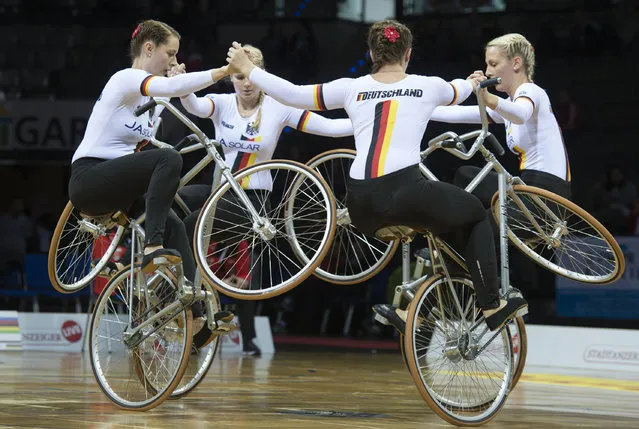 Germany's team with (L-R) Katharina Guellich, Christine Posch, Ramona Strassner and Ramona Ressel perform in the Act 4 Open competition during the UCI Indoor Cycling World Championships in Stuttgart, southwestern Germany, on December 2, 2016. (Photo by Thomas Kienzle/AFP Photo)