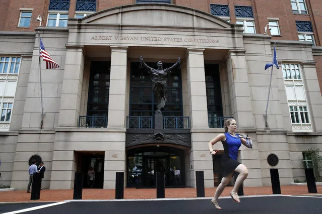 Cassie Semyon, 21, an intern for NBC News, runs from the courthouse with results outside of federal court as jury deliberations are announced in the trial of the former Donald Trump campaign chairman Paul Manafort in Alexandria, Va., Tuesday, August 21, 2018. (Photo by Jacquelyn Martin/AP Photo)