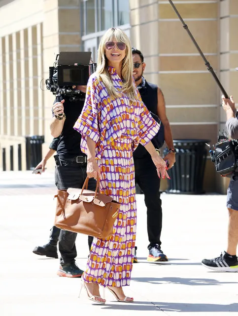 Heidi Klum is all smiles as she arrives to work in Pasadena, California on August 22, 2023, after a European vacation. The German supermodel wore a colorful blouse, matching trousers, and white heels. Much of Hollywood is shut down due to a writers strike, however it does not seem to have an effect on America's Got Talent. (Photo by The Image Direct)